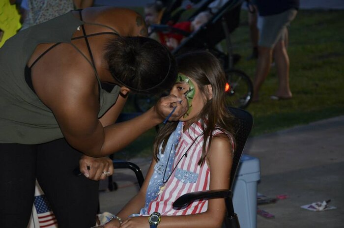 A child gets her face painted during the Joint Base Charleston Freedom Fest celebration June 26, 2015 at Marrington Plantation on JB Charleston - Weapons Station, S.C. More than 1,200 people came out to Marrington Plantation where there was food, games, live music, fireworks and fun for the whole family. Freedom Fest is an annual event at Joint Base Charleston that takes place the last Friday in June at Marrington Plantation. (Courtesy photo / 628th Force Support Squadron)
