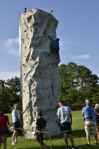 A child climbs the climbing wall at Marrington Plantation during the Joint Base Charleston Freedom Fest celebration June 26, 2016. More than 1,200 people came out to Marrington Plantation where there was food, games, live music, fireworks and fun for the whole family. Freedom Fest is an annual event at Joint Base Charleston that takes place the last Friday in June at Marrington Plantation. (Courtesy Photo / 628th Force Support Squadron)