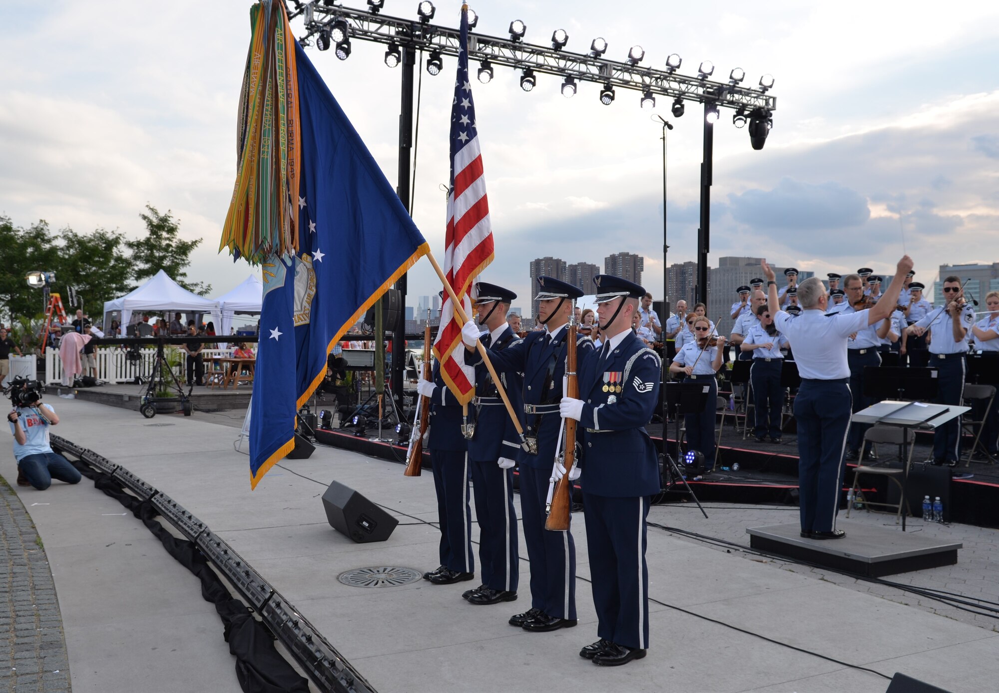 Members of the United States Air Force Honor Guard post the nation’s Colors while the Air Force band performs behind them during a performance at the Macy’s Fireworks Show on July 4, 2015. This performance was part of a larger five-day tour in New York City to represent the Air Force on the nation's birthday (U.S. Air Force photo/1Lt. Esther Willett).