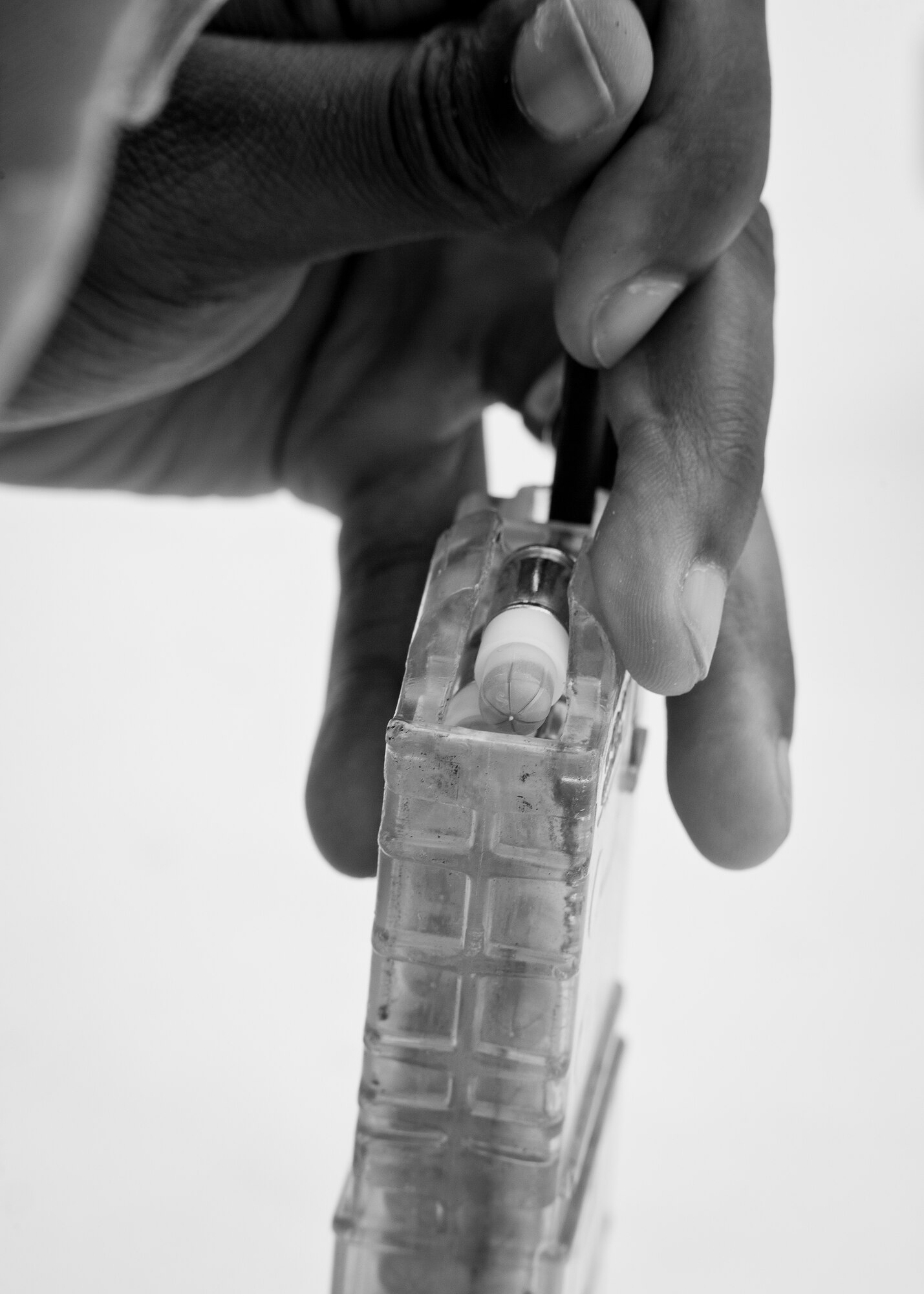 A 96th Security Forces Squadron Airman prepares a simmuntion magazine prior to a shoot, move and communicate drill in June at Eglin Air Force Base, Fla.  The mandatory training requirement is in addition to annual weapons qualification training.  The exercise consists of Airmen firing simmunition ammo while advancing toward, away from and to the side of a target.  This is followed by a building sweep and clear drill.  The Defenders perform the highly kinetic training at Eglin’s Base Tango range.  The range was previously used for security forces pre-deployment training.  (U.S. Air Force photo/Samuel King Jr.)