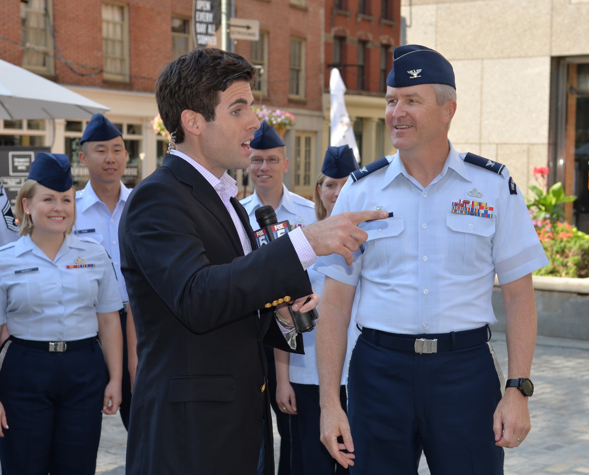 Col. Larry Lang, United States Air Force Band commander, interviews with Robert Moses, a Fox 5 news anchor at the New York Seaport on July 3, 2015. This interview was part of a larger five-day tour in New York City to represent the Air Force on the nation's birthday (U.S. Air Force photo/1Lt. Esther Willett).