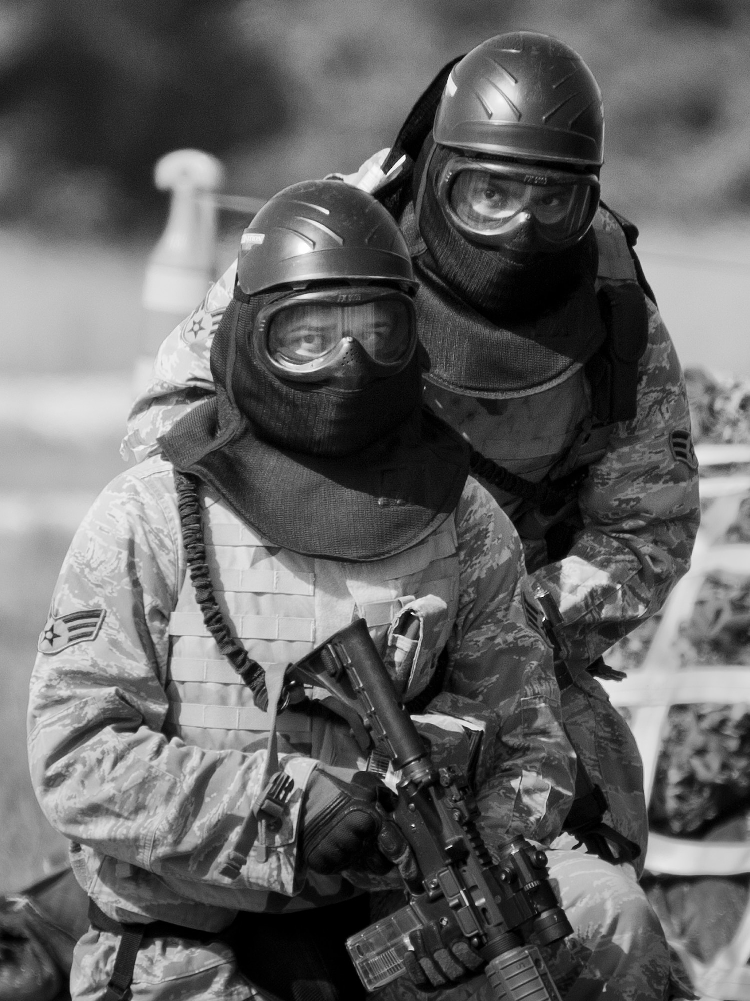 Airmen from the 96th Security Forces Squadron prepare to advance during a shoot, move and communicate drill in June at Eglin Air Force Base, Fla.  The mandatory training requirement is in addition to annual weapons qualification training.  The exercise consists of Airmen firing simmunition ammo while advancing toward, away from and to the side of a target.  This is followed by a building sweep and clear drill.  The Defenders perform the highly kinetic training at Eglin’s Base Tango range.  The range was previously used for security forces pre-deployment training.  (U.S. Air Force photo/Samuel King Jr.)
