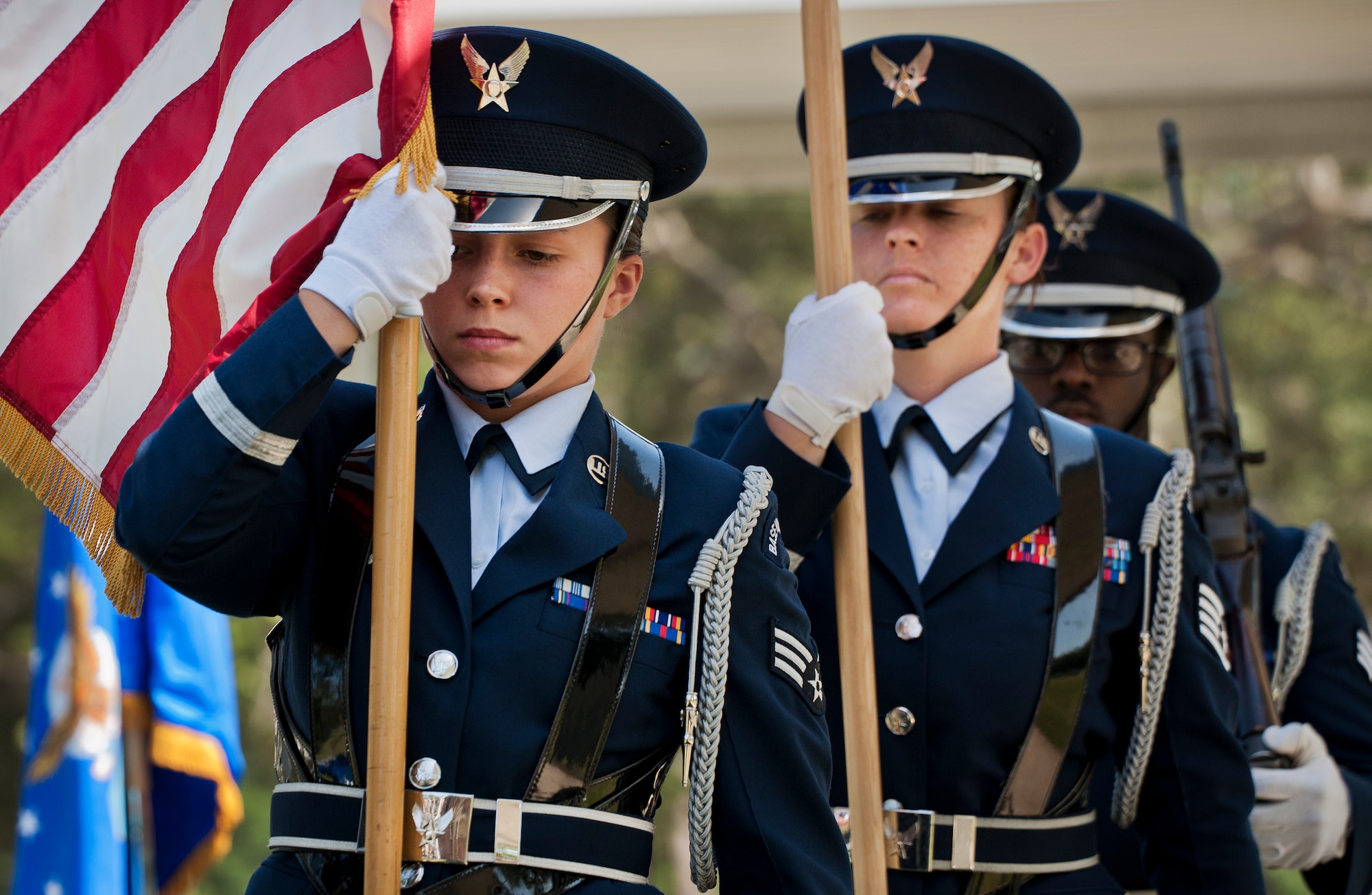 Airman 1st Class Jenna Carr carries the American Flag during an Honor Guard graduation ceremony June 15 at Eglin Air Force Base, Fla. Approximately 12 new Airmen graduated from the 80-plus-hour course. The graduation performance includes flag detail, rifle volley, pall bearers and bugler for friends, family and unit commanders. (U.S. Air Force photo/Samuel King Jr.)