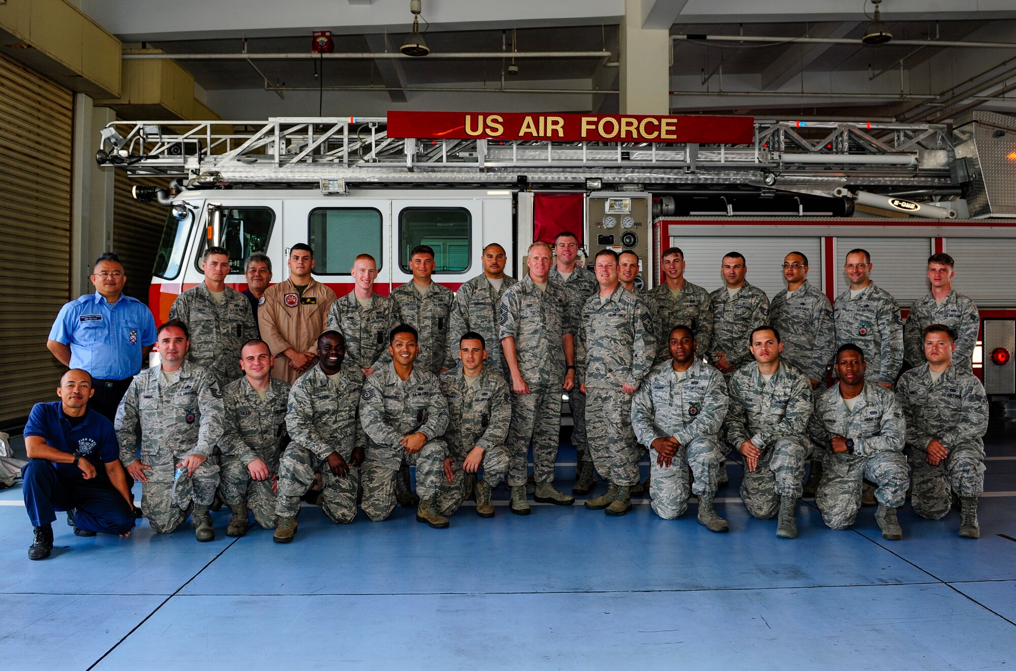 Firefighters from the 18th Civil Engineer Group pose for a photo with Chief Master Sgt. of the Air Force James Cody and Chief Master Sgt. Charles R. Hoffman, 18th Wing command chief, July 6, 2015, at Kadena Air Base, Japan. Cody visited Kadena Airmen to answer questions surrounding changes to the new enlisted evaluation system, promotions, formal training and retirements.