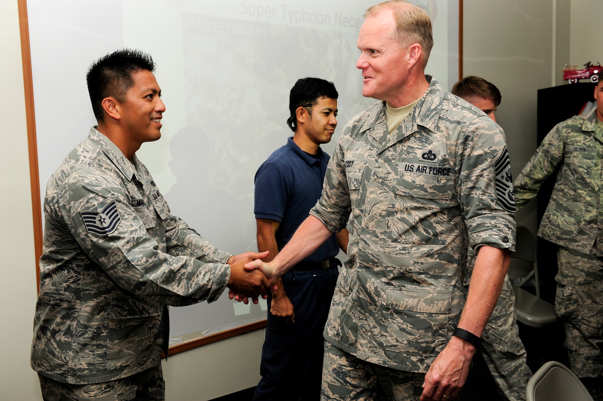 Chief Master Sgt. of the Air Force James Cody shakes hands with Tech. Sgt. Jayson Marquez, 18th Civil Engineer Group firefighter station captain, July 6, 2015, at Kadena Air Base, Japan. In his ongoing efforts to engage with Airmen stationed across the globe, the Air Force’s top enlisted leader is making strides to offer personal answers to Airmen's questions and concerns.