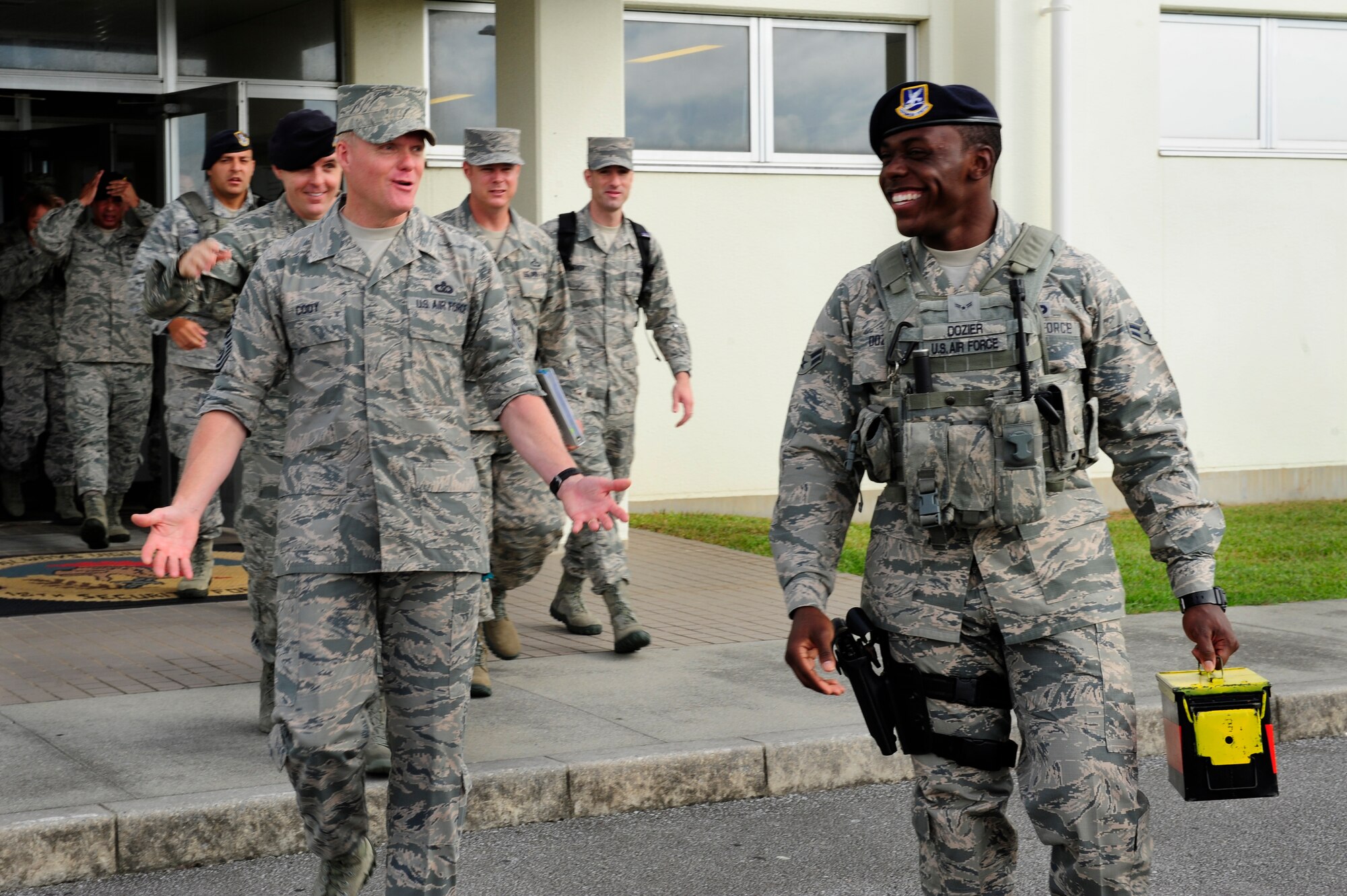 Chief Master Sgt. of the Air Force James Cody walks with Airman 1st Class Nyzavian Dozier, 18th Security Forces Squadron response force leader July 6, 2015, at Kadena Air Base, Japan. Cody joined Dozier for a ride-along and spoke face-to-face with many other Airmen as he visited the different units and personnel that make up Team Kadena. (U.S. Air Force photo by Airman 1st Class John Linzmeier)