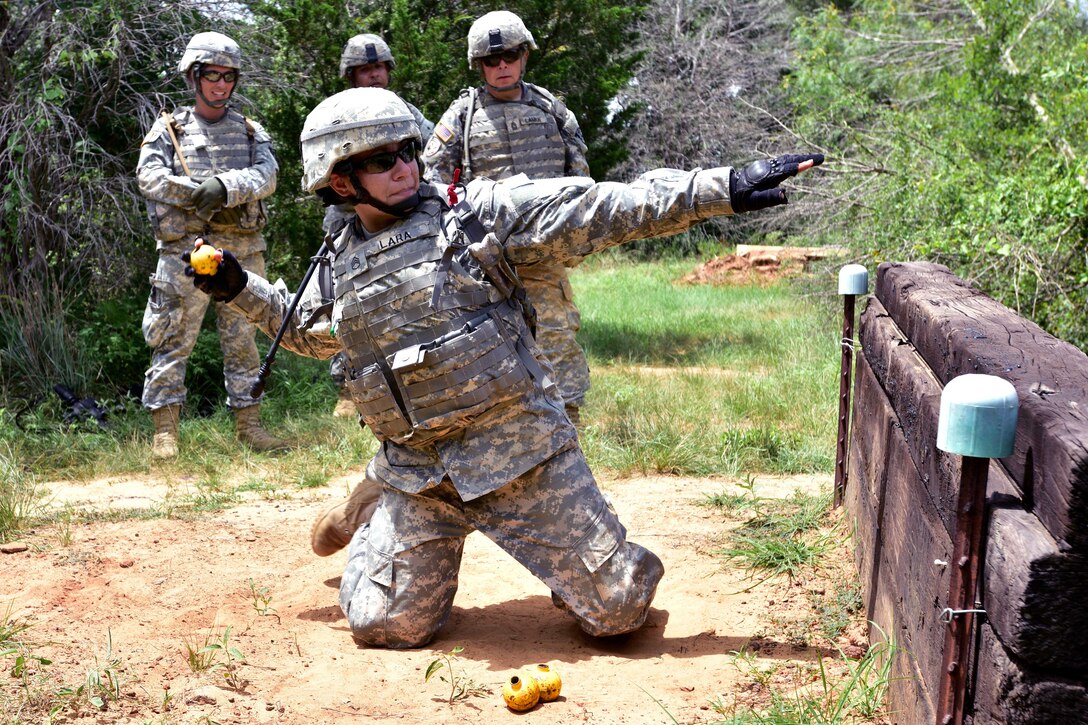 Texas National Guard Army Staff Sgt. Rebecca Lara prepares to throw a practice grenade during pre-mobilization training on Camp Swift in Bastrop, Texas, June 29, 2015. Lara is assigned to the 136th Expeditionary Signal Battalion.