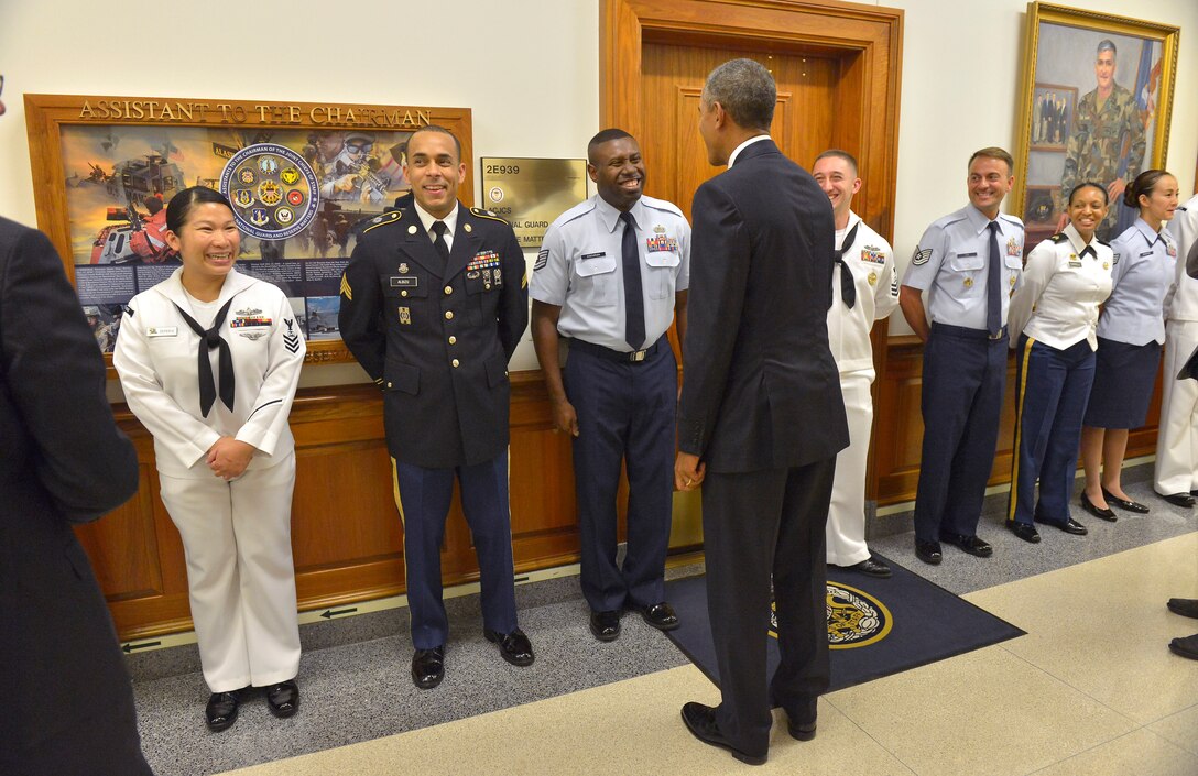 President Barack Obama greets awaiting service members and offers them the presidential coin at the Pentagon, July 6, 2015, after meeting with Defense Secretary Ash Carter.