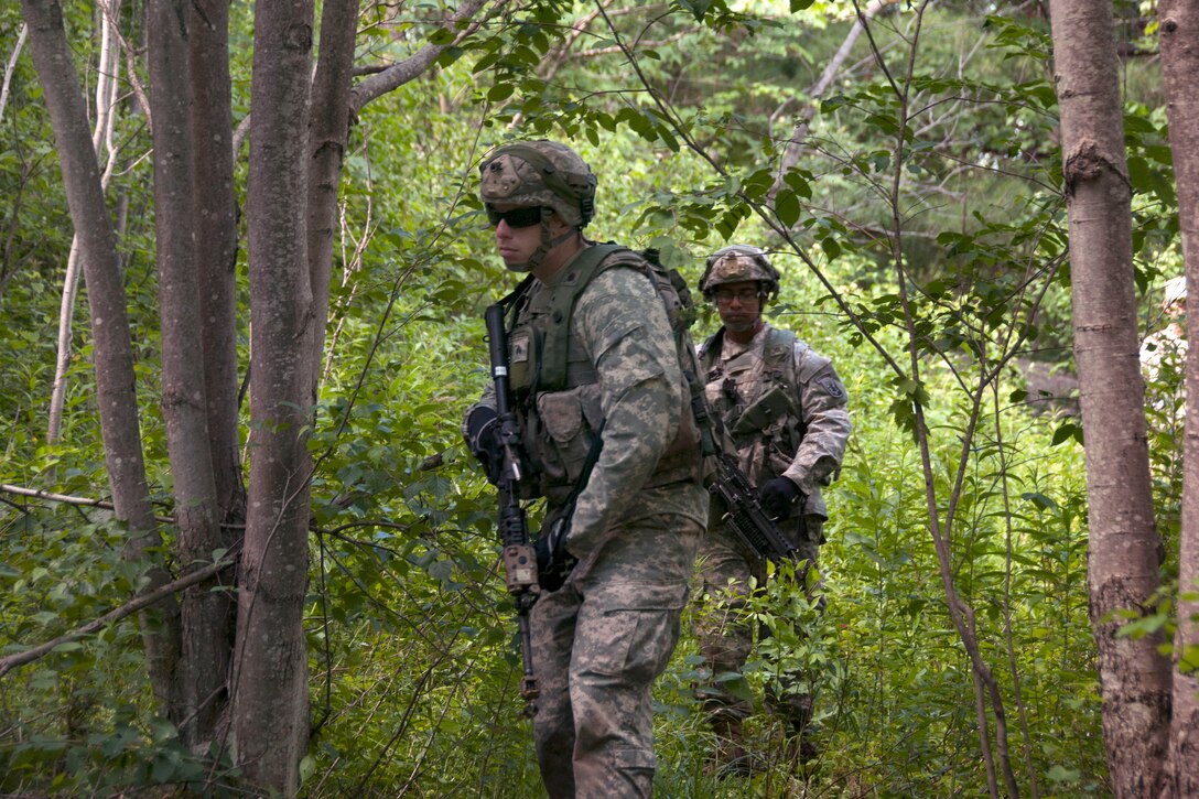 Soldiers patrol toward an objective during the rehearsal portion of a ...