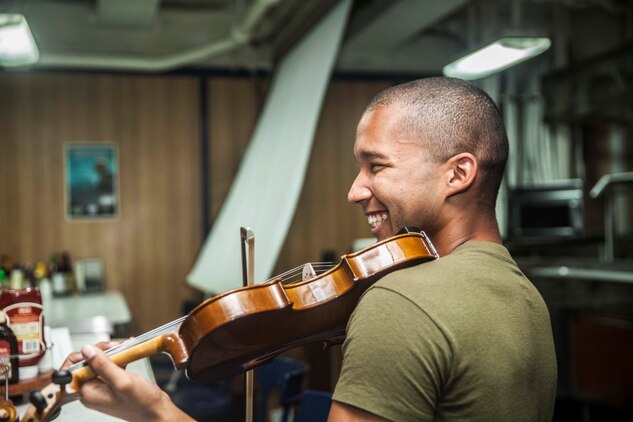 U.S. Marine Cpl. Joshua Backus rehearses a musical selection aboard the dock landing ship USS Rushmore (LSD 47). Backus is a radio technician with Headquarters and Service Company, Battalion Landing Team 3rd Battalion, 1st Marine Regiment, 15th Marine Expeditionary Unit. Music has influenced Backus to master any task he takes on and uses it to inspire others on ship to do the same. The 15th MEU is embarked on the Essex Amphibious Ready Group and deployed to maintain regional security in the U.S. 5th Fleet area of operations. (U.S. Marine Corps photo by Sgt. Emmanuel Ramos/Released)