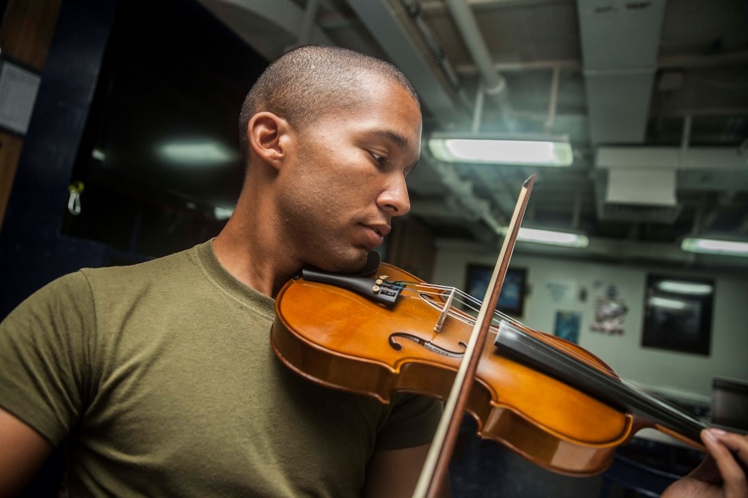 U.S. Marine Cpl. Joshua Backus rehearses a musical selection aboard the dock landing ship USS Rushmore (LSD 47). Backus is a radio technician with Headquarters and Service Company, Battalion Landing Team 3rd Battalion, 1st Marine Regiment, 15th Marine Expeditionary Unit. Music has influenced Backus to master any task he takes on and uses it to inspire others on ship to do the same. The 15th MEU is embarked on the Essex Amphibious Ready Group and deployed to maintain regional security in the U.S. 5th Fleet area of operations. (U.S. Marine Corps photo by Sgt. Emmanuel Ramos/Released)