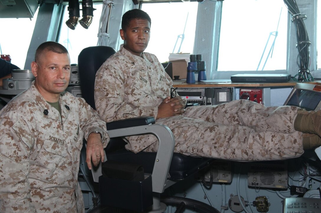 GULF OF ADEN (July 4, 2015) U.S. Marine Sgt. Maj. Douglas Schaefer, left, takes a photo with the 15th Marine Expeditionary Unit’s “Marine of the Week” awardee Lance Cpl. Ezekiel J. Dixon aboard the amphibious assault ship USS Essex (LHD 2). Schaefer is the sergeant major of the 15th MEU and Dixon is a supply administrative clerk and secondary repairable clerk with Combat Logistics Battalion 15, 15th MEU, from Shalimar, Fla. Dixon’s devotion to development and military occupational specialty proficiency is considered well above that of his peers. He is in charge of all secondary repairable exchanges within the 15th MEU. He is directly responsible for all backorders and restocking of all consumed items, and that requires coordination and vast attention to detail. To date, Dixon has retrograded and exchanged over $1.5 million in parts, including consumed items. The 15th MEU is embarked on the Essex Amphibious Ready Group and deployed to maintain regional security in the U.S. 5th Fleet area of operations. (U.S. Marine Corps photo by Staff Sgt. Miguel Carrasco/Released)