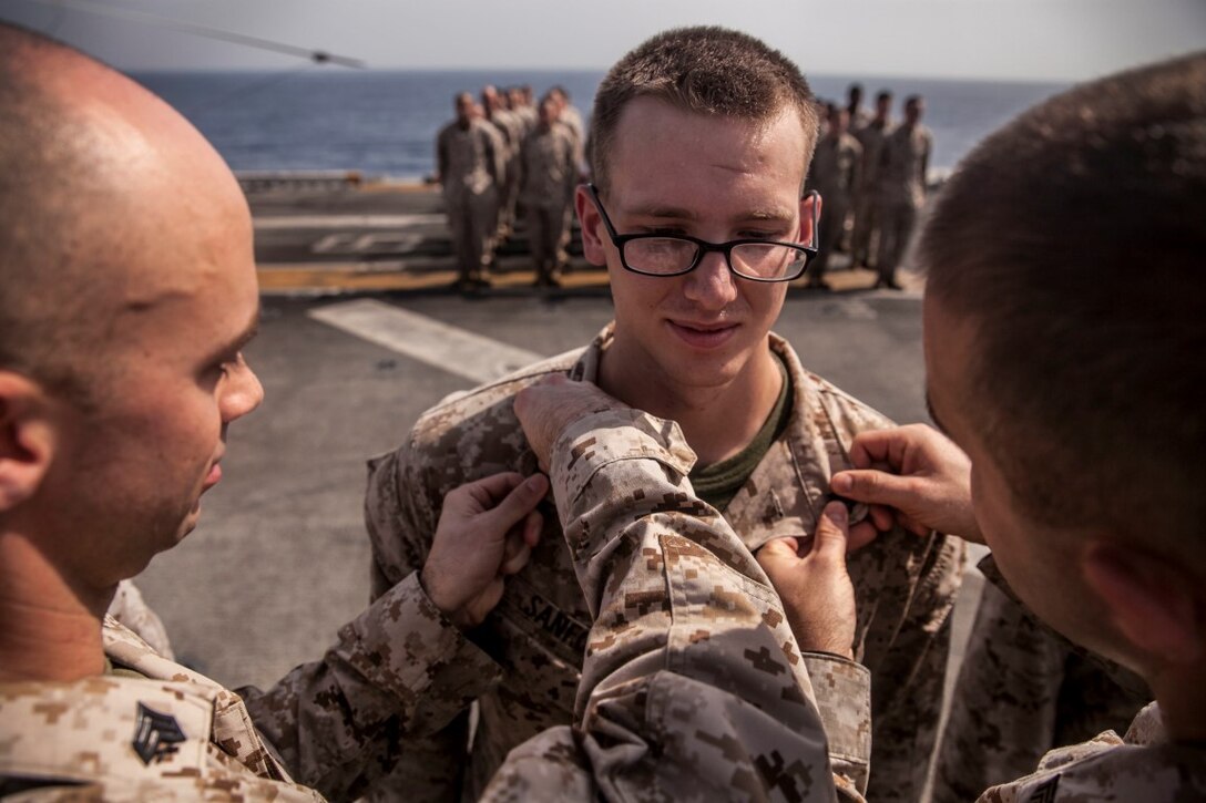 U.S. Marine Sgt. Michael Sanford is pinned by his fellow Marines from the 15th Marine Expeditionary Unit during a promotion ceremony aboard the amphibious assault ship USS Essex (LHD 2). The 15th MEU is embarked on the Essex Amphibious Ready Group and is deployed in support of maritime security operations and theater security cooperation efforts in the U.S. 5th Fleet area of operations. (U.S. Marine Corps photo by Cpl. Elize McKelvey/ Released)