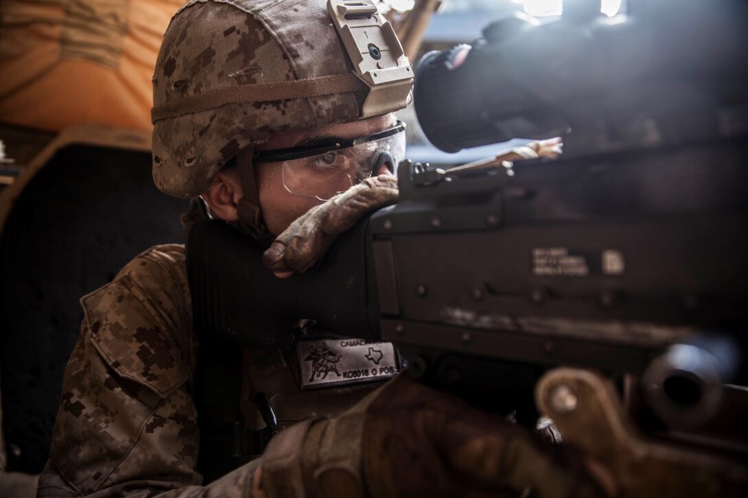 U.S. Marine Lance Cpl. Jamie Camacho aims in on an M240B machine gun during mounted-weapons drills aboard the dock landing ship USS Rushmore (LSD 47). Camacho is an automatic rifleman with Kilo Company, Battalion Landing Team 3rd Battalion, 1st Marine Regiment, 15th Marine Expeditionary Unit. During the training, Marines rehearsed mounting and dismounting the M240B, reload drills, and engaging multiple targets. The 15th MEU is embarked on the Essex Amphibious Ready Group and deployed to maintain regional security in the U.S. 5th Fleet area of operations. (U.S. Marine Corps photo by Sgt. Emmanuel Ramos/Released)
