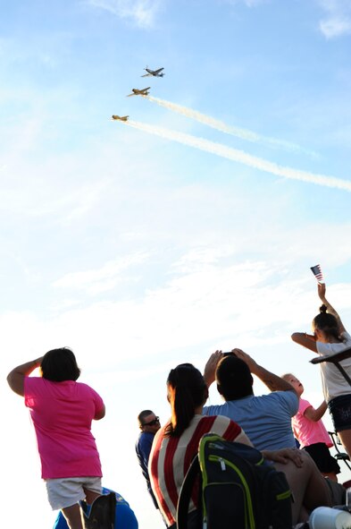 Onlookers observe a fly over during Fireworks on the Water July 4, 2015 at the Stennis Lock and Dam, Columbus, Mississippi. During the event attendees enjoyed free music, children’s activities and fireworks. (U.S. Air Force photo by Airman 1st Class Daniel Lile)