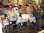Aeromedical evacuation team members and volunteers at Ramstein Air Base, Germany, position a critically wounded warrior for a flight aboard a C-17 Globemaster III to Joint Base Andrews, Md., April 29, 2011.
