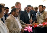 Abdul Rahman Kabiri (left), Panjshir Province deputy governor, Air Force Lt. Col. Joseph Blevins (center), commander of the Panjshir Provincial Reconstruction Team, a part of the 2nd Brigade Combat Team, 34th Infantry Division, Task Force Red Bulls, and Abdul Mohammad, the Panjshir director of education, cut the ribbon across the entrance of the Baba Ali Girls School in Dara District, Afghanistan May 1, 2011. The PRT contracted the local Raz Tanha Construction Company to build the school in a remote district of Panjshir.