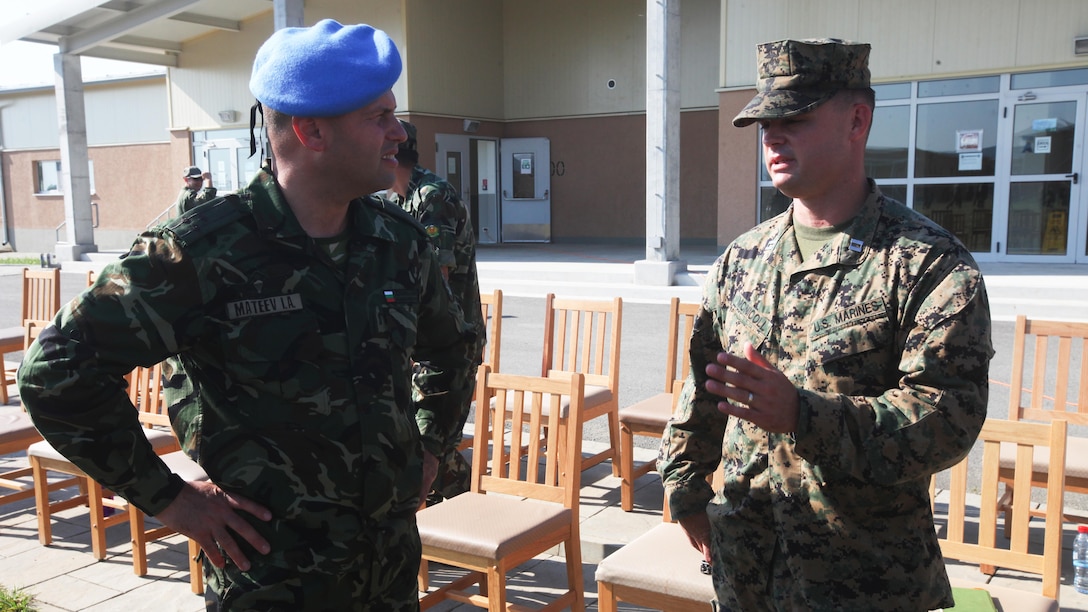 Bulgarian Army Col. Iavor Mateev and U.S. Marine Corps Capt. Michael R. McNicoll talk following the opening ceremony of Platinum Lion 15-3. The two-week training exercise is designed to strengthen the partnerships between the NATO nations and share knowledge to help improve their military skill sets.  Mateev is Head of the Joint Military Facilities Department at the Bulgarian Defense Ministry and McNicoll is the commanding officer of Golf Company, 2nd Battalion, 8th Marine Regiment, Black Sea Rotational Force.