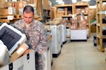 Army Spc. John Millan, technical supply specialist, Bravo Company, 640th Aviation Support Battalion, California National Guard, helped inventory parts that were discovered at Camp Taji, Iraq, saving the Army million of dollars, seen here on May 3, 2011.