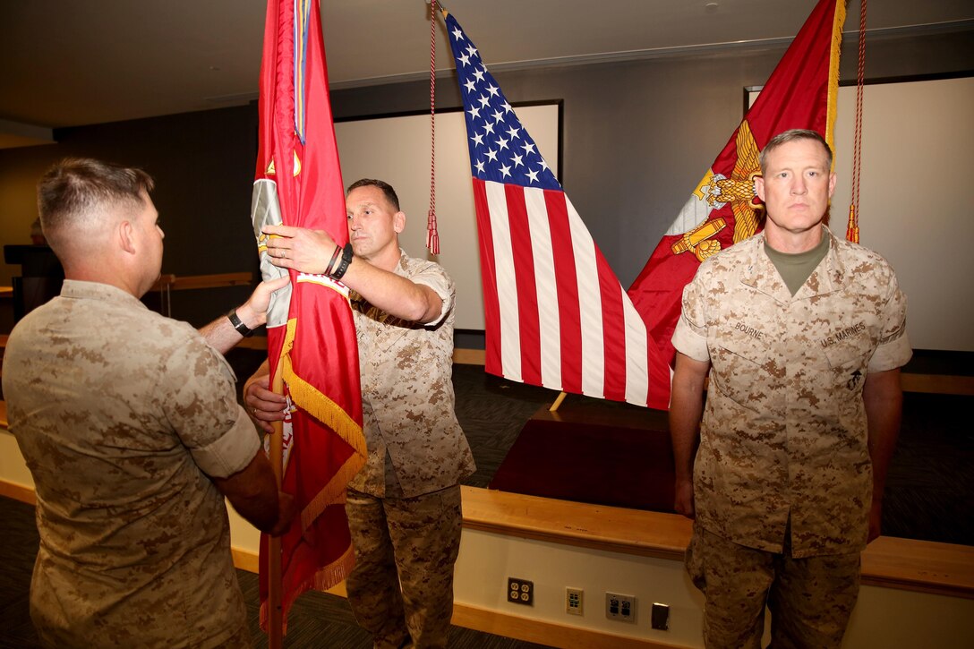 MARINE CORPS BASE CAMP LEJEUNE, N.C.—Colonel Neil C. Schuehle relinquishes command of Marine Special Operations School to Col. Brett A. Bourne during a change-of-command ceremony at the U.S. Marine Corps Forces, Special Operations Command headquarters at Stone Bay, aboard Marine Corps Base Camp Lejeune, N.C., July 1, 2015. (U.S. Marine Corps Photo by Sgt. Donovan Lee/released)