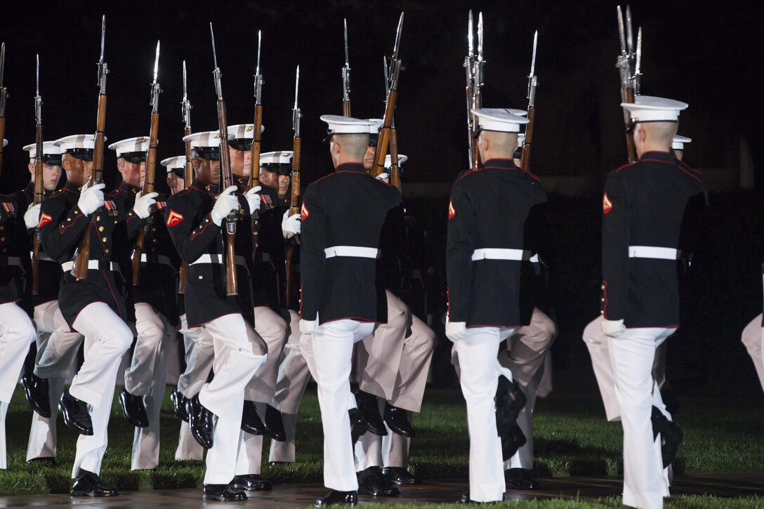 The U.S. Marine Corps Silent Drill Platoon preforms during an evening parade at Marine Barracks Washington, D.C., July 3, 2015. The Honorable, Dr. Jack Dyer Crouch II, CEO and president of the USO, was the guest of honor for the July 3 Evening Parade, and Lt. Gen. Mark Brilakis, commanding general Marine Corps Recruiting Command, was the hosting official for that same parade. Evening Parade summer tradition began in 1934 and features the Silent Drill Platoon, the U.S. Marine Band, the U.S. Marine Drum and Bugle Corps and two marching companies. More than 3,500 guests attend the parade every week. (U.S. Marine Corps photo by Lance Cpl. Kayla V. McTaw/ Released)