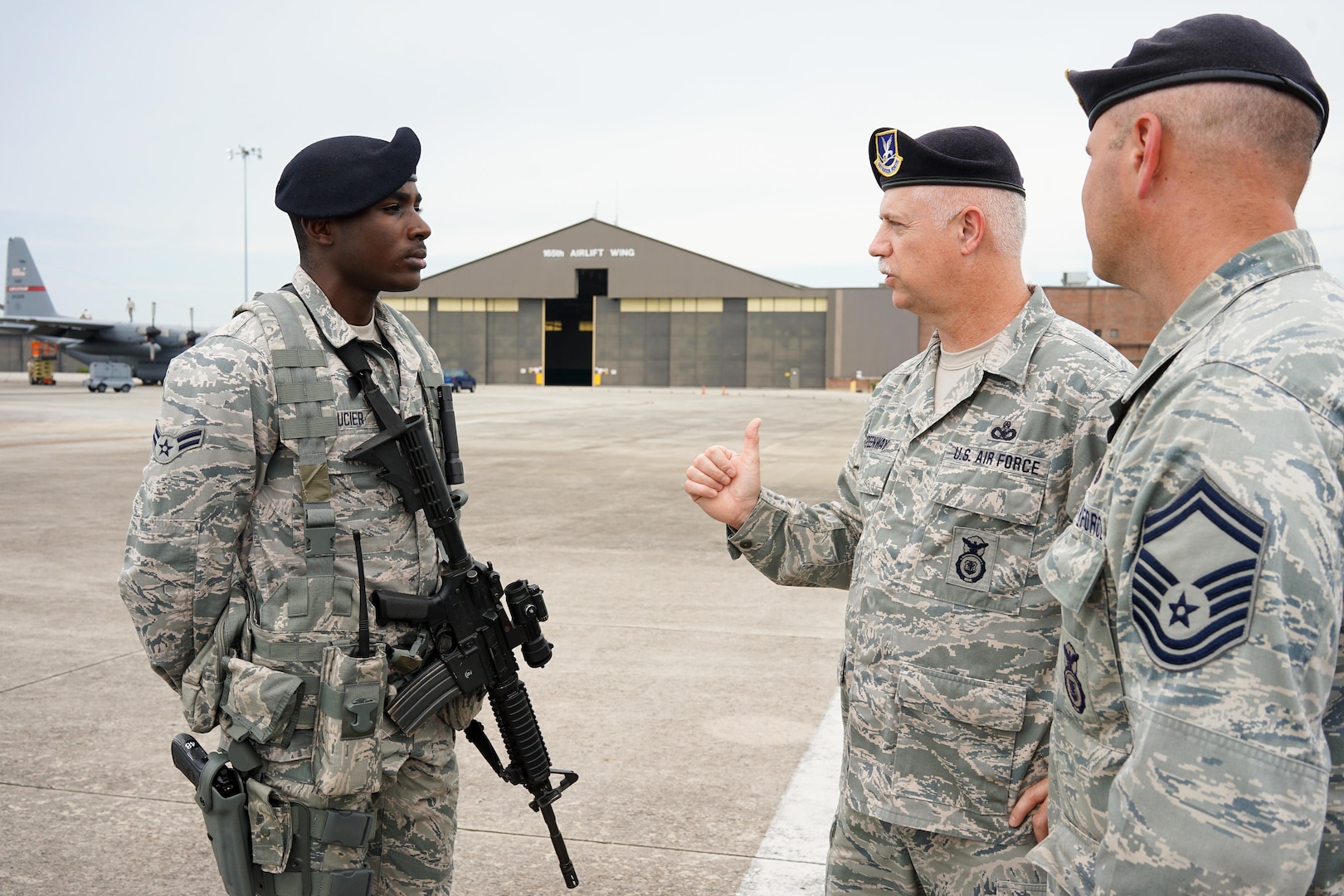 U.S. Air Force Chief Master Sgt. William Greenway, center, 116th Security Forces Squadron (SFS) Manager, questions Airman 1st Class Devajia Saucier, left, while Senior Master Sgt. James Miller, 116th SFS operations superintendent looks on, during a post briefing on the flightline at Joint Base Savannah, Ga., June 23, 2015. The JSTARS cops from the Georgia Air National Guard’s 116th Air Control Wing completed 15 days of law enforcement and flightline security training during their annual tour at Joint Base Savannah.