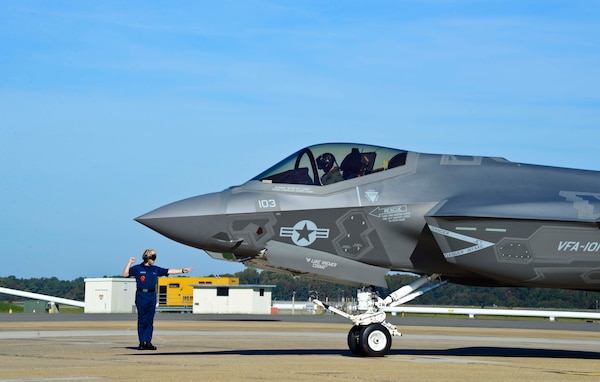 Lt. Scott Cleveland, assigned to Strike Fighter Squadron (VFA) 101, is directed to park the F-35C Lightning II Joint Strike Fighter after landing at Naval Air Station Oceana. the aircraft will provide fleet aviators and maintainers an opportunity to view the aircraft and receive briefings from the flight crew and maintainers. The aircraft is the carrier variant of the Lockheed Martin built aircraft and is assigned to VFA-101 based at Eglin Air Force Base, Fla. (U.S. Navy photo by Mass Communication Specialist Seaman Kayla King/Released)