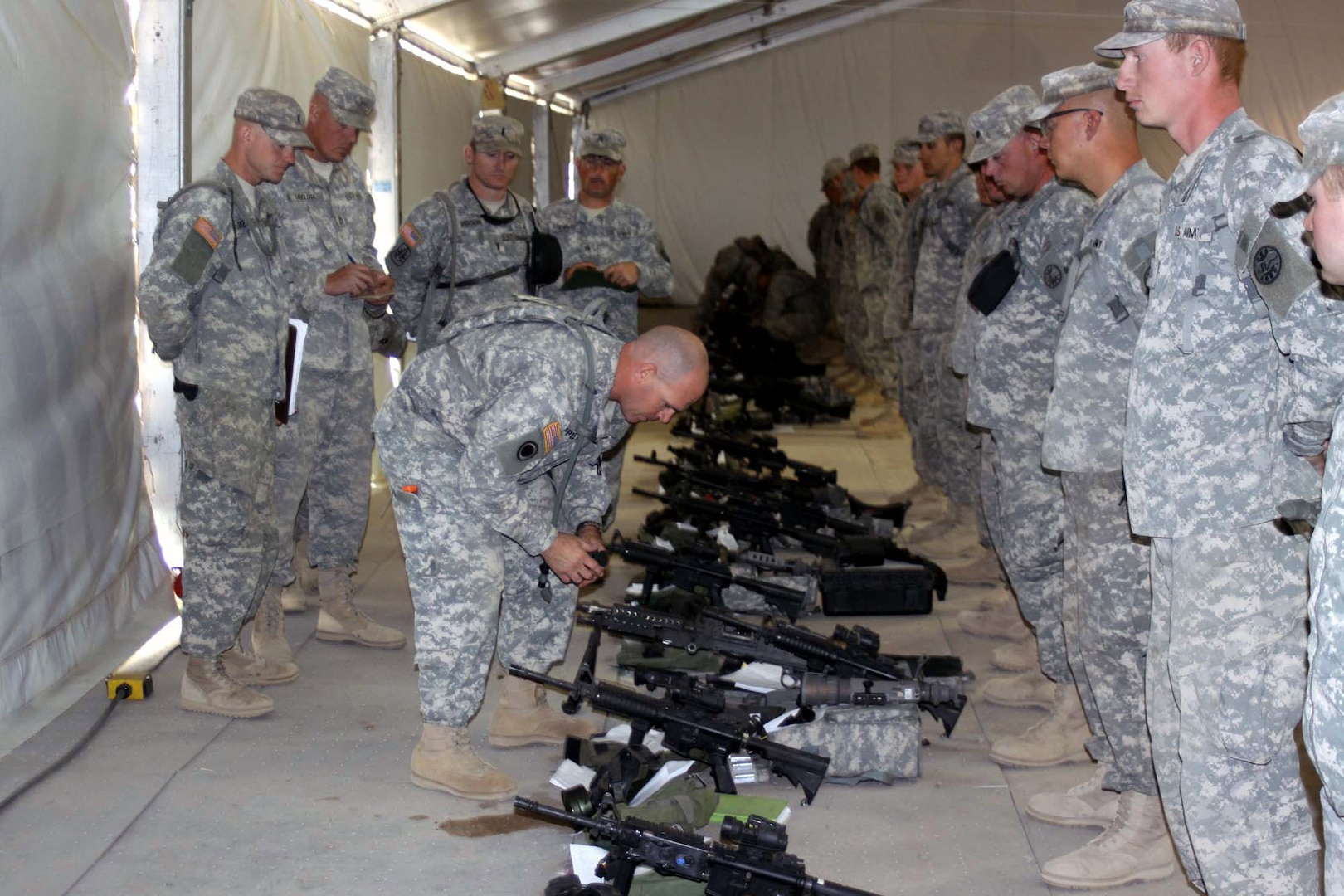 Army Lt. Col. Phil Appleton, commander of the 3rd Battalion, 116th Cavalry Regiment, 77th Sustainment Brigade, 310th Expeditionary Sustainment Command, conducts a pre-combat inspection of weapons of Company Foxtrot, 3rd Battalion. Pre-combat checks and pre-combat inspections are critical elements in the fight against complacency.