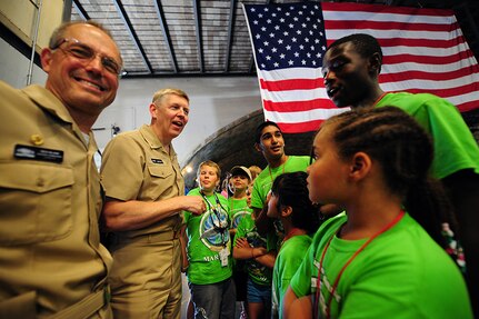 150624-N-FJ200-130 WEST BETHESDA, Md. (June 24, 2015) Rear Adm. Lorin Selby, second from left, commander of Naval Surface Warfare Center, and Capt. Richard Blank, commanding officer of Naval Surface Warfare Center, Carderock Division, visit the team "KIDS Team Nautilus" from southern Maryland, during the 13th International Human-Powered Submarine Races in the David Taylor Model Basin at Naval Surface Warfare Center, Carderock Division in West Bethesda, Md. (U.S. Navy photo by Mass Communication Specialist 1st Class Clifford L.H. Davis/Released)