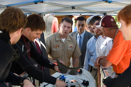 150624-N-PO203-275 BETHESDA, Md. (June 24, 2015) Capt. Robert Palisin, assistant chief of naval research, and Dr. Michael Simpson, director of education and workforce at the Office of Naval Research, talk with students from Virginia Tech University about their human-powered submarine, Phantom 7, during the 13th International Human-Powered Submarine Race (ISR) taking place at the David Taylor Model Basin at the Naval Surface Warfare Center Carderock Division. (U.S. Navy photo by John F. Williams/Released)