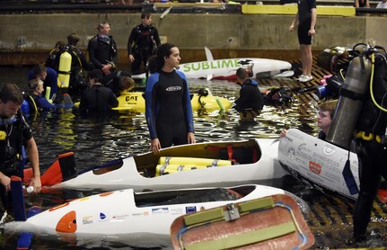 150624-N-PO203-233 
BETHESDA, Md. (June 24, 2015) Competitors prepare their submarines during the 13th International Human-Powered Submarine Race (ISR) being held in the David Taylor Model Basin at the Naval Surface Warfare Center Carderock Division. The mission of the ISR is inspire students of various engineering disciplines to explore broad areas of underwater technology advancement, foster advances in subsea vehicle hydrodynamic, propulsion and life support systems and to increase the public awareness of the challenges people face in working in the and exploring the ocean depths. (U.S. Navy photo by John F. Williams/Released)        