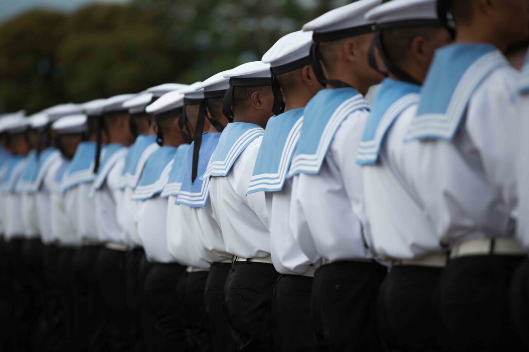 Tongan sailors stand in formation while waiting for the coronation ceremony to begin, July 4, 2015. The U.S. Marine Corps Forces, Pacific Band supports the coronation ceremonies by performing in celebrations and parades alongside their counterparts from Tonga, Australia and New Zealand.