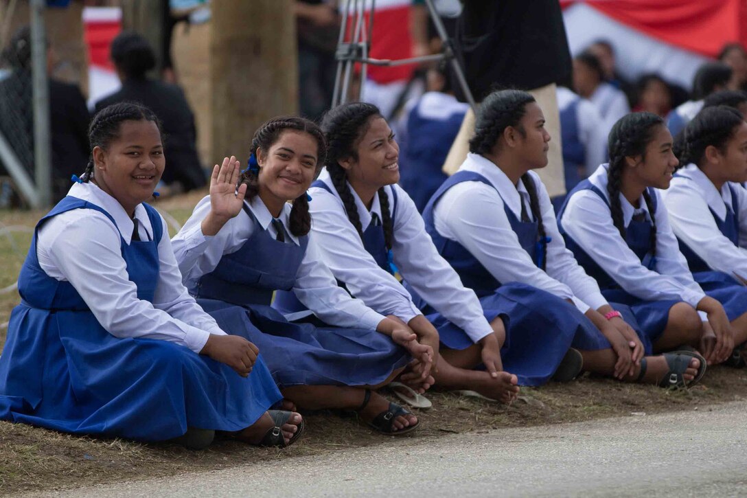 Tongan girls wait for King Tupou VI to arrive for his coronation ceremony in Nuku'alofa, Tonga, July 4, 2015. The U.S. Marine Corps Forces, Pacific Band participated in the coronation ceremonies alongside bands from Tonga, Australia and New Zealand. 