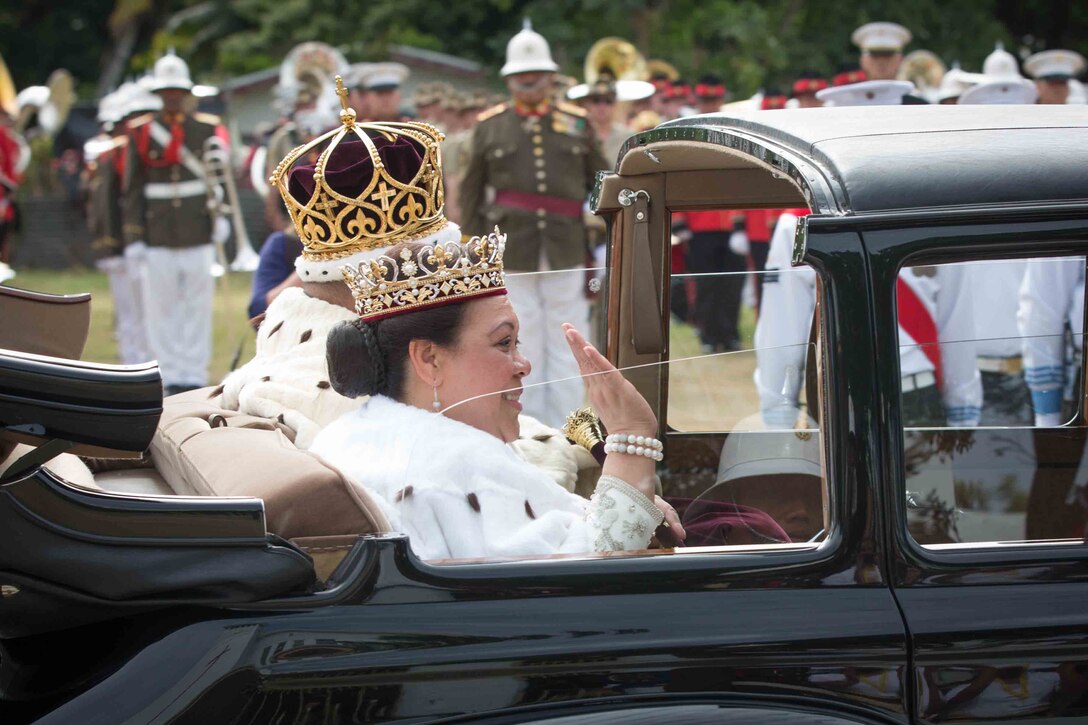 The King and Queen of Tonga ride away after His Majesty's Coronation in Nuku'alofa, Tonga, July 4, 2015. After participating in the King’s Birthday Celebration and military tattoo in 2011, the U.S. Marine Corps Forces, Pacific Band accepted the invitation to participate in the Coronation events, honoring the King of Tonga and His Majesty’s Armed Forces. 