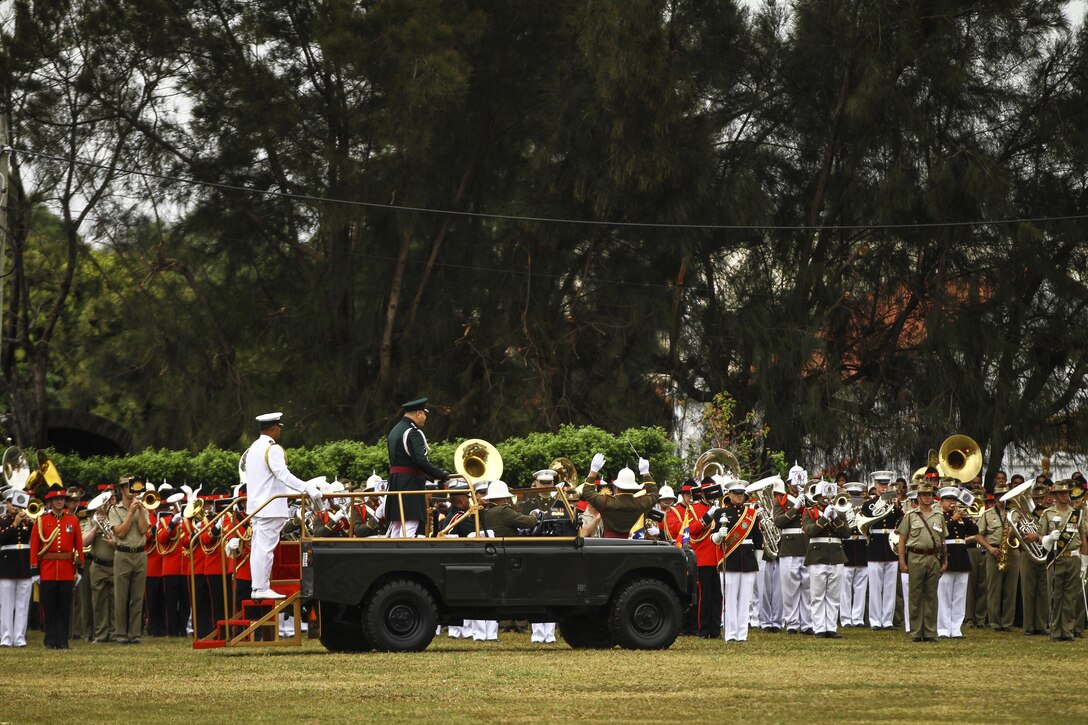 King Tupou VI observes the the mass band that includes U.S. Marines, Tongan, New Zealand, and Australian soldiers in Nuku'alofa, Tonga, July 6, 2015. The U.S. Marine Corps Forces, Pacific Band travels throughout the Pacific region to promote community relations and interoperability between the U.S. and other countries.