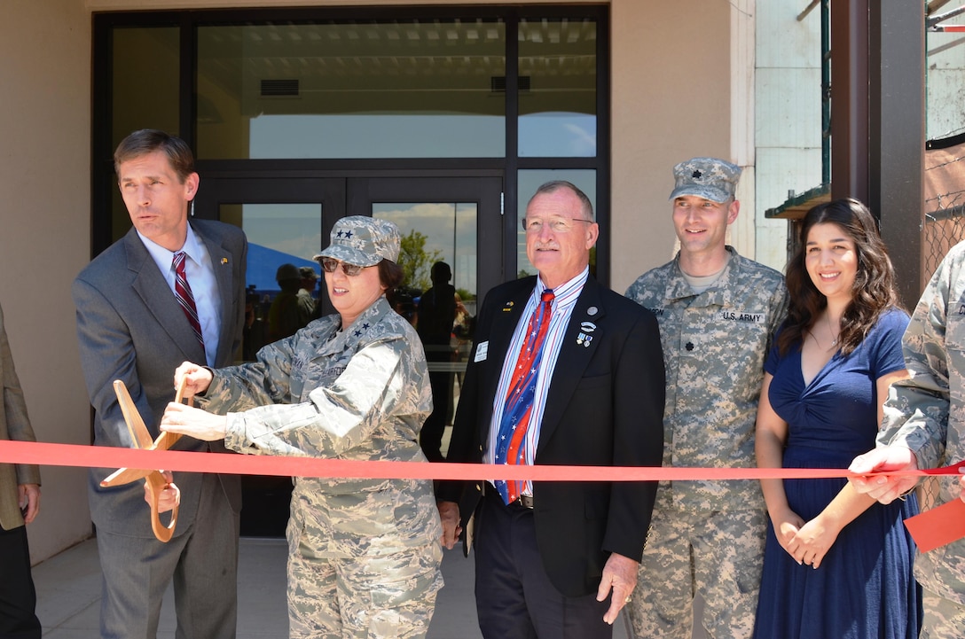 KIRTLAND AIR FORCE BASE, N.M. – District Commander Lt. Col. Patrick Dagon, second from right, watches as Sen. Martin Heinrich, far left, and Maj. Gen. Sandra Finan, commander of the Air Force Nuclear Weapons Center, cut the ribbon to officially open Phase 1 of the Air Force Nuclear Weapons Center expansion, June 29, 2015.  