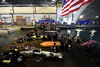 150624-N-PO203-128 
BETHESDA, Md. (June 24, 2015) Competitors prepare their submarines during the 13th International Human-Powered Submarine Race (ISR) being held in the David Taylor Model Basin at the Naval Surface Warfare Center Carderock Division. The mission of the ISR is inspire students of various engineering disciplines to explore broad areas of underwater technology advancement, foster advances in subsea vehicle hydrodynamic, propulsion and life support systems and to increase the public awareness of the challenges people face in working in the and exploring the ocean depths. (U.S. Navy photo by John F. Williams/Released)        