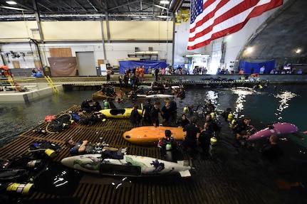 150624-N-PO203-128 
BETHESDA, Md. (June 24, 2015) Competitors prepare their submarines during the 13th International Human-Powered Submarine Race (ISR) being held in the David Taylor Model Basin at the Naval Surface Warfare Center Carderock Division. The mission of the ISR is inspire students of various engineering disciplines to explore broad areas of underwater technology advancement, foster advances in subsea vehicle hydrodynamic, propulsion and life support systems and to increase the public awareness of the challenges people face in working in the and exploring the ocean depths. (U.S. Navy photo by John F. Williams/Released)        