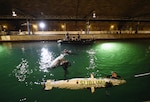 150624-N-PO203-076 
BETHESDA, Md. (June 24, 2015) Navy divers from the Explosive Ordnance Disposal Technical Division at Indian Head, Md., assist student teams with their human-powered submarines during the 13th International Human-Powered Submarine Race (ISR) being held in the David Taylor Model Basin at the Naval Surface Warfare Center Carderock Division. ISR is a unique international engineering design competition that inspires high school and college-age students of the various engineering disciplines to pursue careers in science, technology, engineering and mathematics (STEM). (U.S. Navy photo by John F. Williams/Released)              