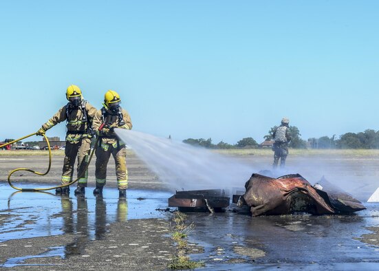 Suffolk Fire Department firefighters extinguish flames on aircraft debris during exercise Diamond Dragon at Royal Air Force Honington, England, June 30, 2015. Diamond Dragon is a three-day, joint forces response exercise that readies members of the U.K. Ministry of Defence, emergency response agencies and the U.S. Air Force for incidents that require help from both nations. (U.S. Air Force photo/Senior Airman Nigel Sandridge)
