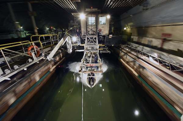 150406-N-PO203-199 
WEST BETHESDA, Md. (April 3, 2015) A ship hull model attached to a high-speed sled moves through waves at the David Taylor Model Basin at Naval Surface Warfare Center, Carderock, during Office of Naval Research -sponsored research. The research studies the fundamental physics of the water-impact of high-speed planing hulls and to measure the slamming loads and resulting motions of the craft upon re-entry into the water. (U.S. Navy photo by John F. Williams/Released)                                                                                                            