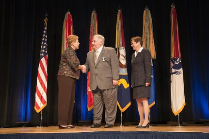 141107-N-ZZ999-001 WASHINGTON (Nov. 7, 2014) Under Secretary of Defense for Personnel and Readiness Jessica Wright congratulates Dr. John Holmes, a senior scientist in the Underwater Electromagnetic Signatures and Technology Division, Naval Surface Warfare Center Carderock Division, after awarding him the Department of Defense Distinguished Civilian Service Award as Principal Deputy Assistant Secretary of the Navy for Manpower and Reserve Affairs Anne Davis looks on, at the Pentagon. This award is the highest honor that a Defense Department civilian employee can receive. (U.S. Navy photo/Released)