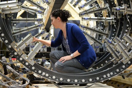 141015-N-AP853-002 WEST BETHESDA, Md. (Oct. 15, 2014) Jessica McElman, an electrical engineer at Naval Surface Warfare Center, Carderock Division, adjusts a magnetic field sensor in the model track located in the Magnetic Fields Laboratory in West Bethesda, Md. (U.S. Navy photo by Nicholas Malay/Released)