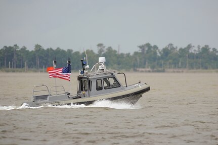 140812-N-PO203-560 NEWPORT NEWS, Va. (Aug. 12, 2014) An unmanned 27-foot harbor security boat from Naval Surface Warfare Center Carderock operates autonomously during an Office of Naval Research-sponsored demonstration of swarmboat technology on the James River in Newport News, Va. During the demonstration as many as 13 Navy boats, using an Office of Naval Research-sponsored system called CARACaS (Control Architecture for Robotic Agent Command Sensing), operated autonomously or by remote control during escort, intercept and engage scenarios. (U.S. Navy photo by John F. Williams/Released)