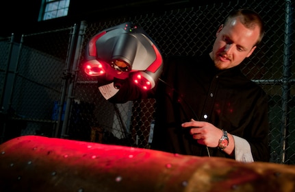 140430-N-TH437-001 WASHINGTON (April 30, 2014) Scott Storms, a project engineer at Naval Surface Warfare Center Carderock Division, makes a 3-dimensional scan of the number 24 Howell Torpedo at the Underwater Archeology Branch (UAB) of the Naval History and Heritage Command (NHHC) on the Washington Navy Yard. Lost from the Iowa (BB 4) during a training mission and found by a dolphin in the U.S. Navy Marine Mammal Program off the coast of San Diego last year, UAB has been desalinating the torpedo since May 2013. (U.S. Navy photo by Mass Communication Specialist 2nd Class Eric Lockwood/Released)