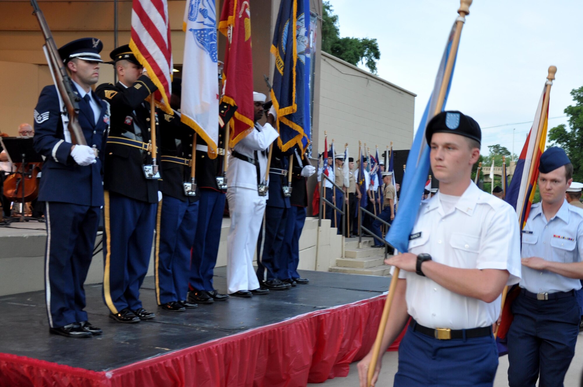 Goodfellow Air Force Base service members salute the United States flag during the San Angelo Symphony’s Pops Concert at the Bill Aylor Sr. Memorial RiverStage in San Angelo, Texas, July 3, 2015. Service members assited at the event by displaying flags, ushering and providing a Rockwell B-1 Lancer flyover. (U.S. Air Force photo by Senior Airman Joshua Edwards/Released)