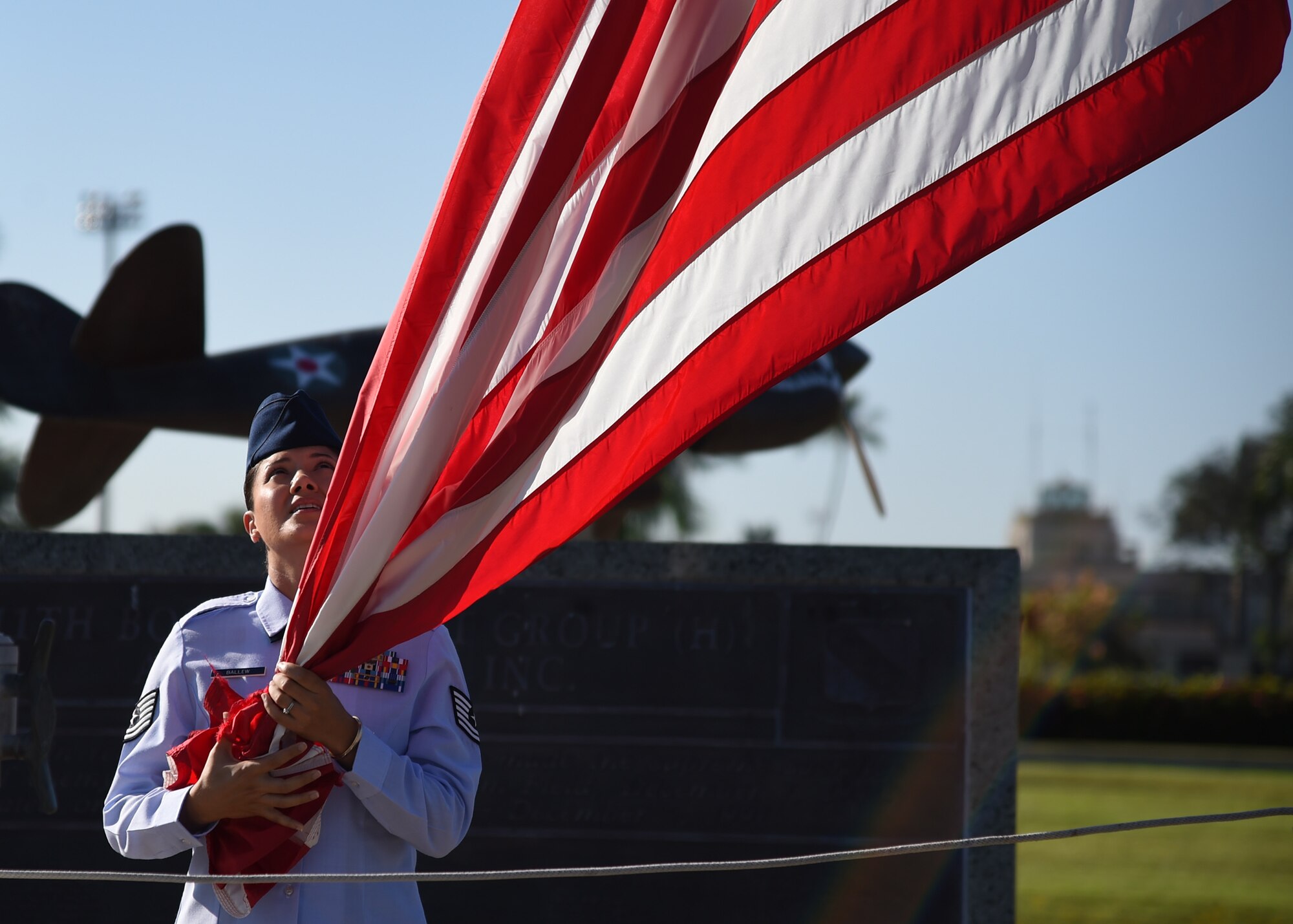 Tech. Sgt. Eloise Ballew, 747th Communications Squadron, secures the U. S. flag prior to Reveille on Joint Base Pearl Harbor-Hickam, Hawaii, July 2, 2015. The ceremony was performed by 60 Airmen from the 747th CS in honor of Independence Day. (U.S. Air Force photo by Tech. Sgt. Aaron Oelrich/Released)  