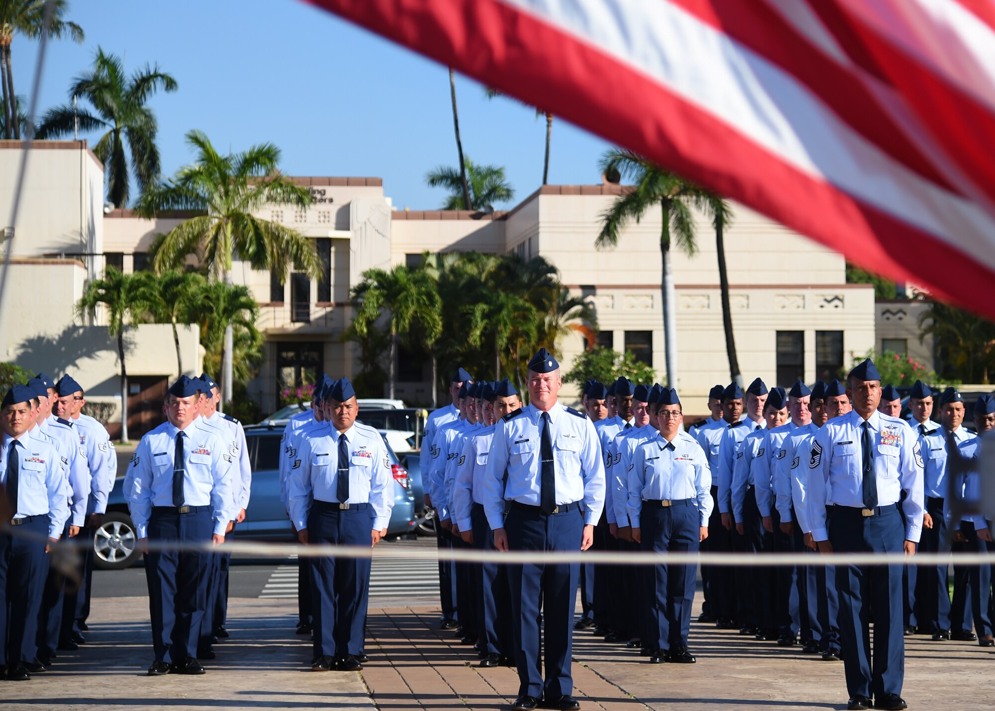 U.S. Air Force Lt. Col. Jeffrey Guimarin, 747th Communication Squadron commander, commands the 747th Communication flight during a Reveille ceremony on Joint Base Pearl Harbor-Hickam, Hawaii, July 2, 2015. The ceremony was performed by 60 Airmen from the 747th CS in honor of Independence Day. (U.S. Air Force photo by Tech. Sgt. Aaron Oelrich/Released) 