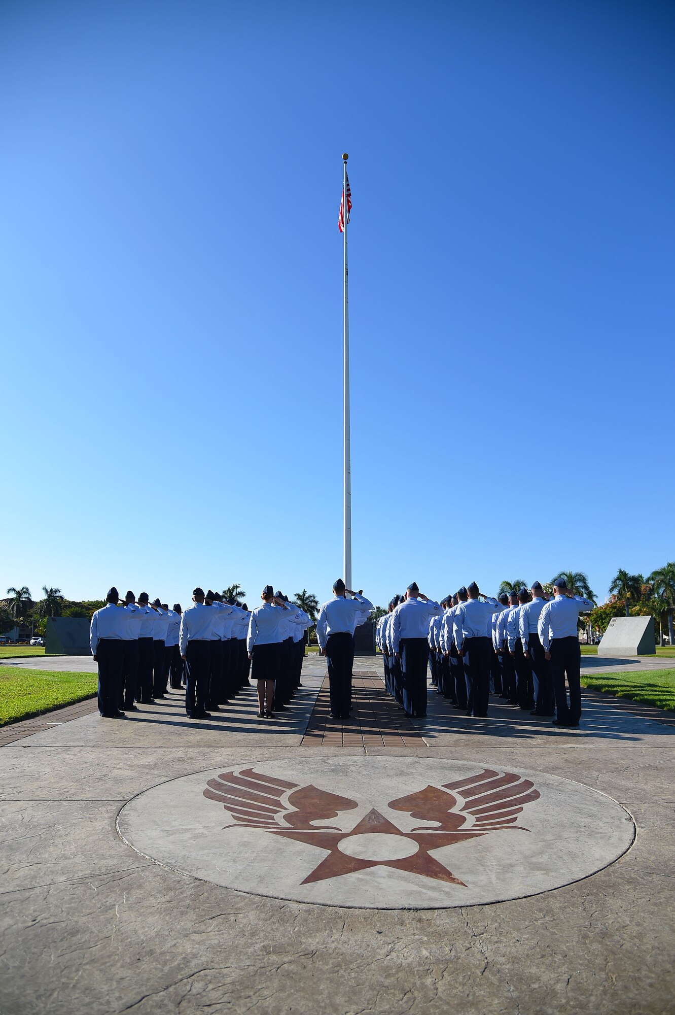 Members of the 747th Communications Squadron salute the U.S. flag during a Reveille ceremony on Joint Base Pearl Harbor-Hickam, Hawaii, July 2, 2015.The ceremony was performed by 60 Airmen from the 747th CS in honor of Independences Day. (U.S. Air Force photo by Tech. Sgt. Aaron Oelrich/Released) 
