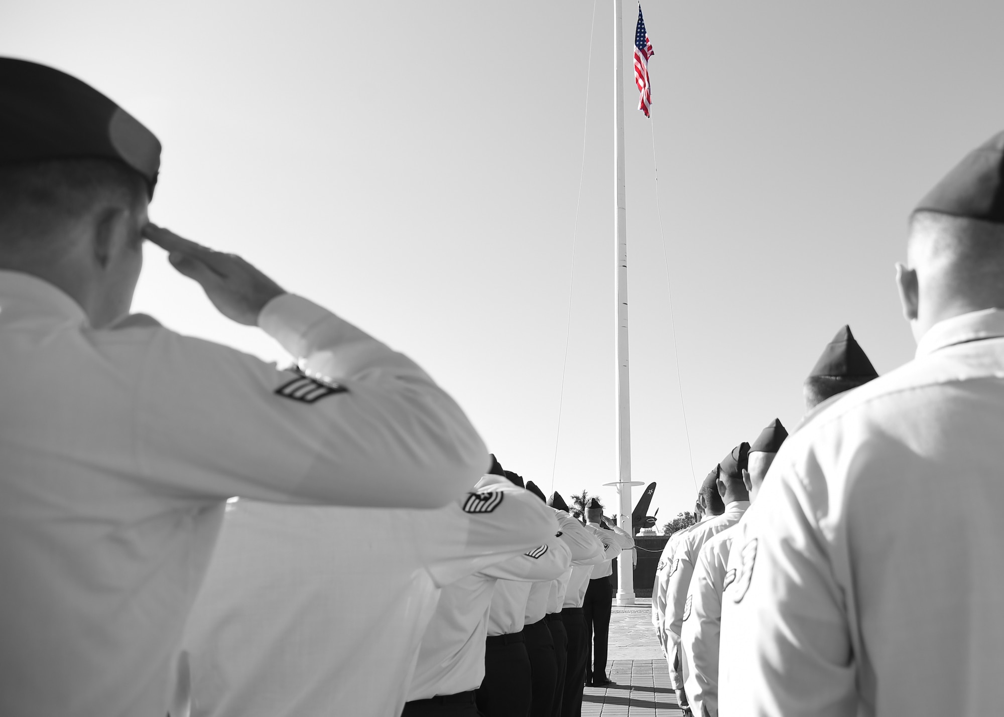 Members of the 747th Communications Squadron salute the U.S. flag during a Reveille ceremony on Joint Base Pearl Harbor-Hickam, Hawaii, July 2, 2015.The ceremony was performed by 60 Airmen from the 747th in honor of Independence Day. (U.S. Air Force illustration by Tech. Sgt. Aaron Oelrich/Released) 
